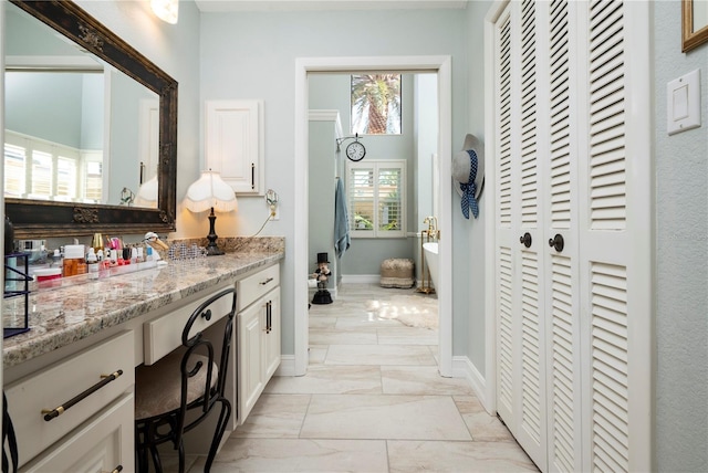 bathroom featuring a bath and vanity