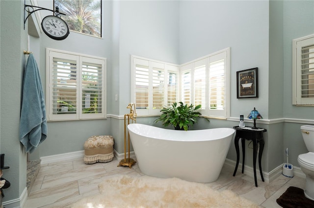 bathroom featuring a bathing tub and toilet