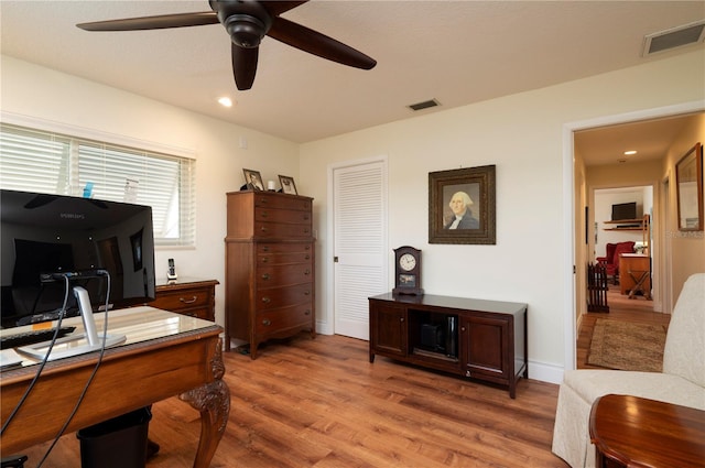 office space with light wood-type flooring and ceiling fan