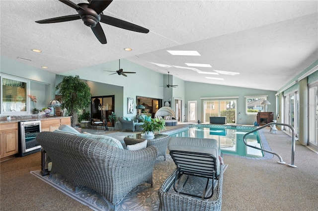 living room featuring dark colored carpet, wine cooler, a textured ceiling, and ceiling fan