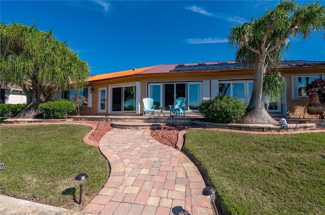 back of property featuring a yard and a patio area