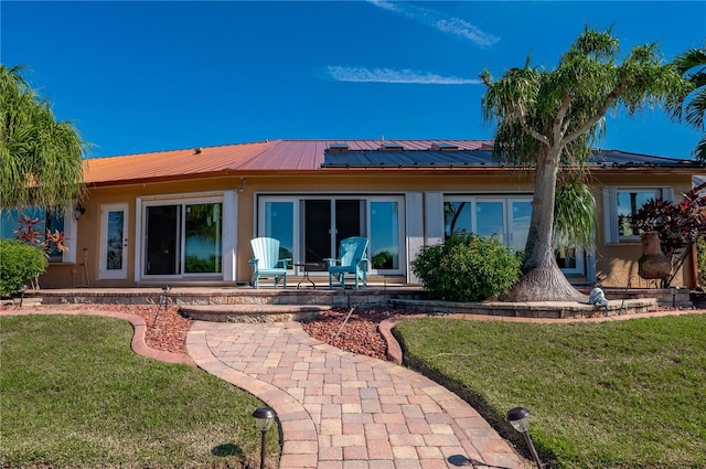 back of house with a lawn and a patio area