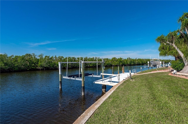 dock area with a lawn and a water view