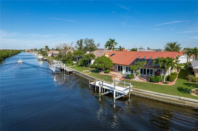 view of dock featuring a lawn and a water view