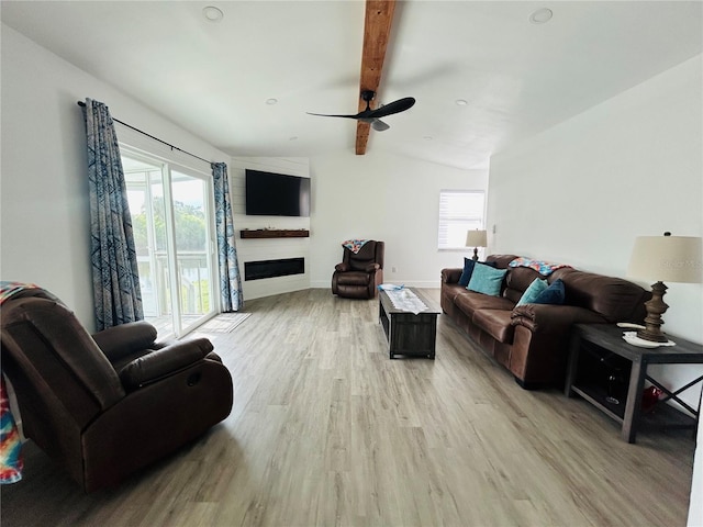 living room featuring vaulted ceiling with beams, light hardwood / wood-style floors, ceiling fan, and plenty of natural light