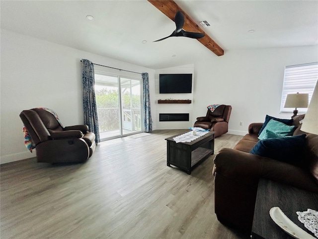 living room with light wood-type flooring, vaulted ceiling with beams, and ceiling fan