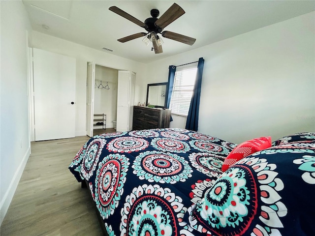 bedroom with light hardwood / wood-style flooring, a closet, and ceiling fan