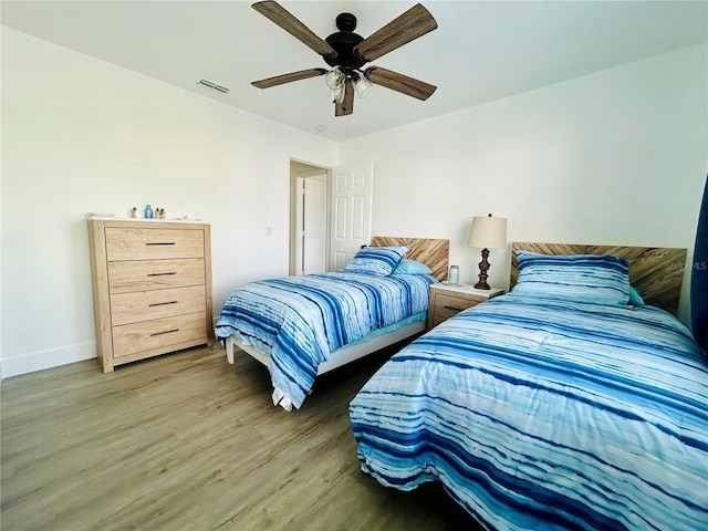 bedroom with wood-type flooring and ceiling fan