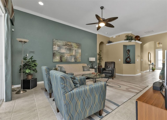 tiled living room with ceiling fan and ornamental molding