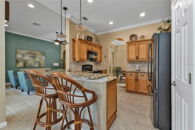 kitchen featuring kitchen peninsula, tasteful backsplash, ornamental molding, ceiling fan, and black appliances