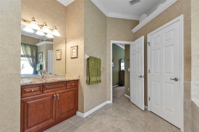 bathroom with tile patterned flooring, vanity, and crown molding