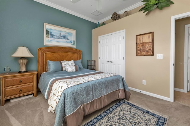 bedroom with light carpet, a closet, ornamental molding, and ceiling fan