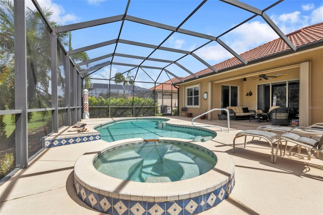 view of pool featuring ceiling fan, a lanai, an in ground hot tub, and a patio