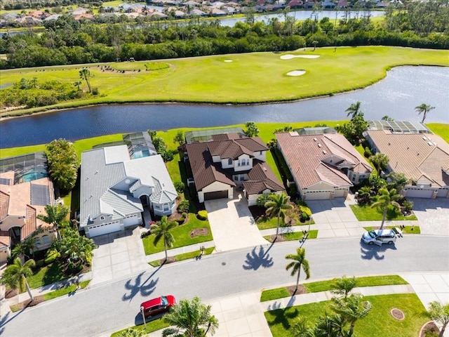 birds eye view of property with a water view, view of golf course, and a residential view