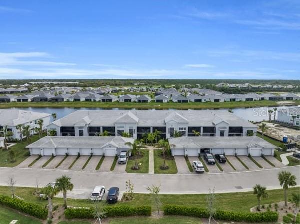 bird's eye view featuring a residential view and a water view