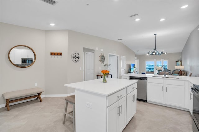 kitchen with a center island, sink, white cabinets, an inviting chandelier, and stainless steel appliances