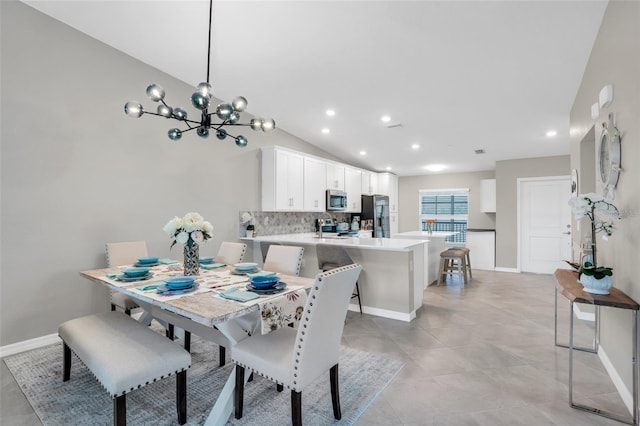 tiled dining space with a notable chandelier and vaulted ceiling