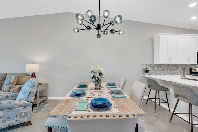 tiled dining room with lofted ceiling, a chandelier, and sink