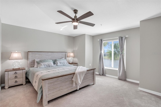 bedroom with ceiling fan and light colored carpet