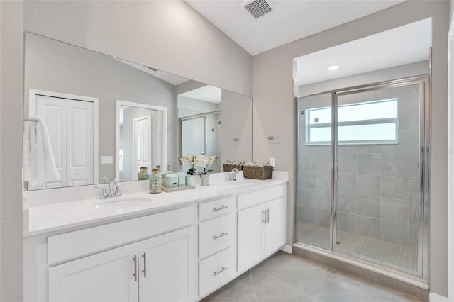 bathroom featuring lofted ceiling, tile patterned floors, a shower with door, and vanity