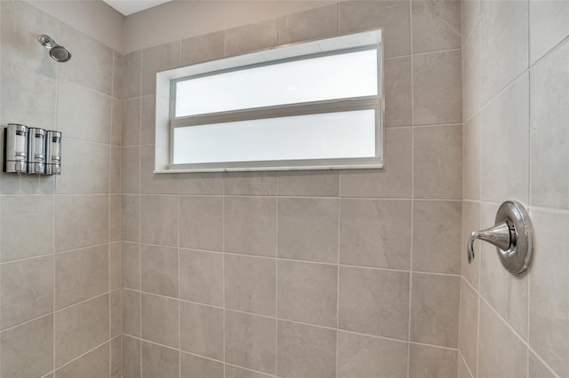 bathroom with a tile shower