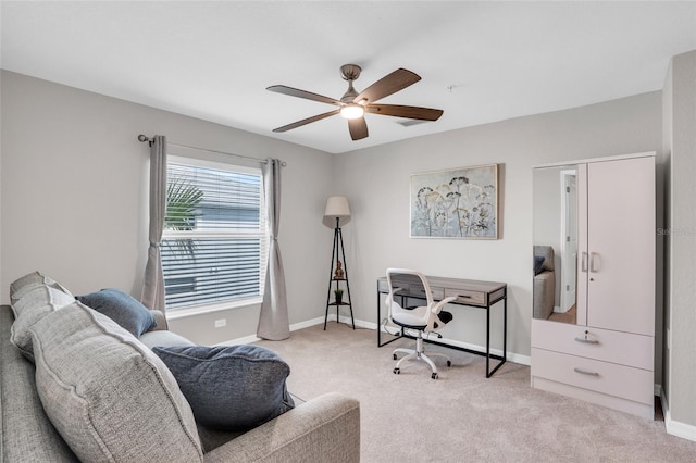 carpeted office space featuring ceiling fan