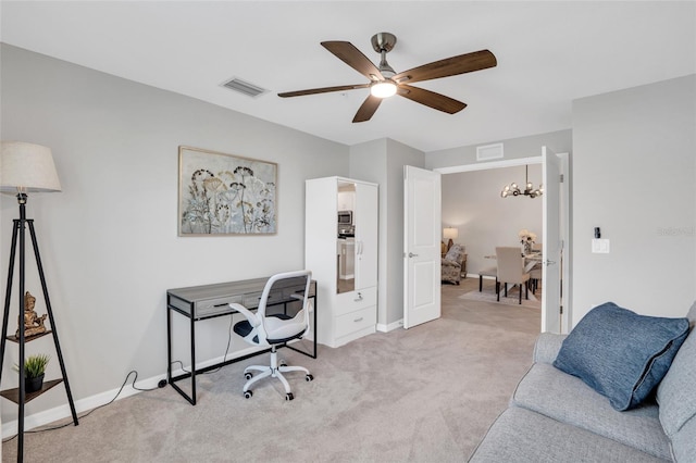 carpeted office featuring ceiling fan with notable chandelier