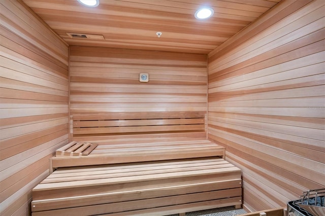 view of sauna with wooden walls and wooden ceiling