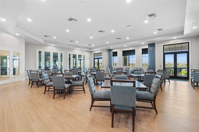 dining area featuring french doors, visible vents, and light wood finished floors