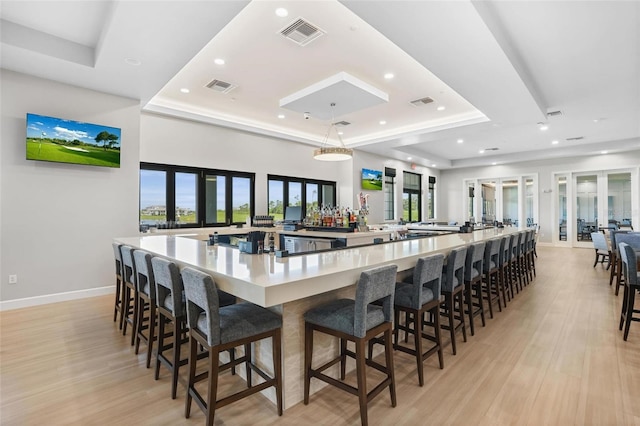 interior space featuring a raised ceiling, visible vents, and french doors