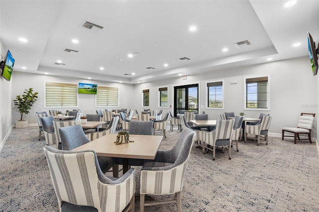 dining space featuring a tray ceiling, visible vents, and recessed lighting