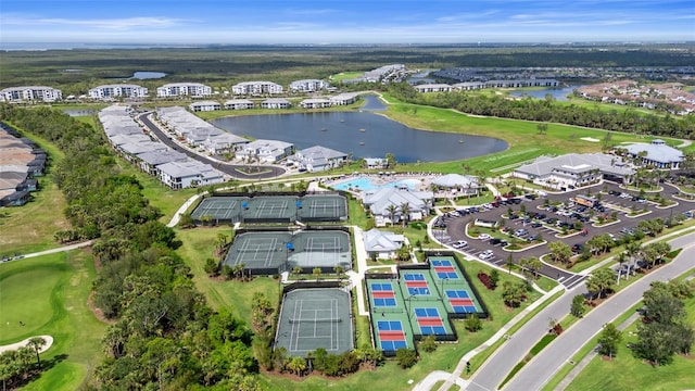 birds eye view of property with a water view and golf course view