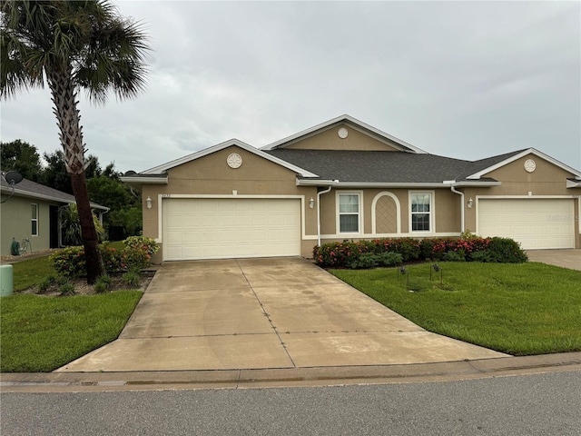 single story home with a front yard and a garage