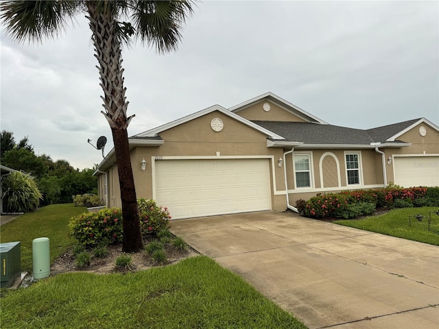 ranch-style house with a garage and a front lawn