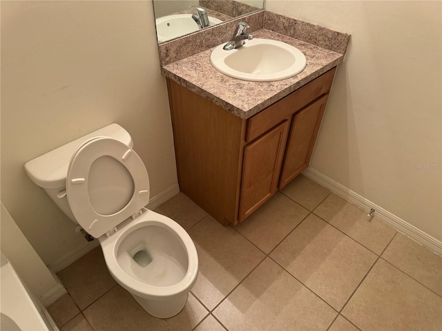 bathroom featuring vanity, tile patterned flooring, and toilet