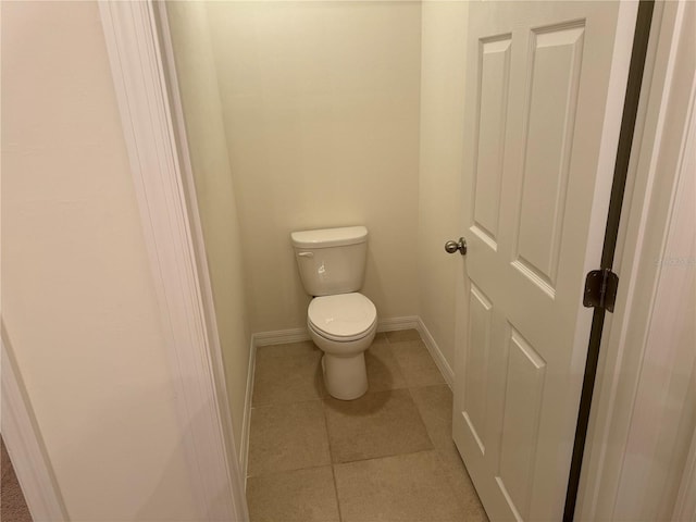 bathroom with tile patterned flooring and toilet