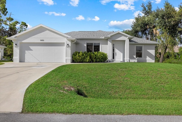 single story home featuring a garage and a front lawn