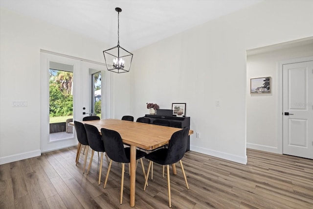 dining space featuring a notable chandelier and hardwood / wood-style floors