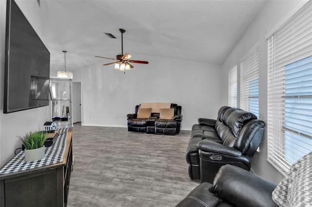 living room featuring ceiling fan, wood-type flooring, and vaulted ceiling