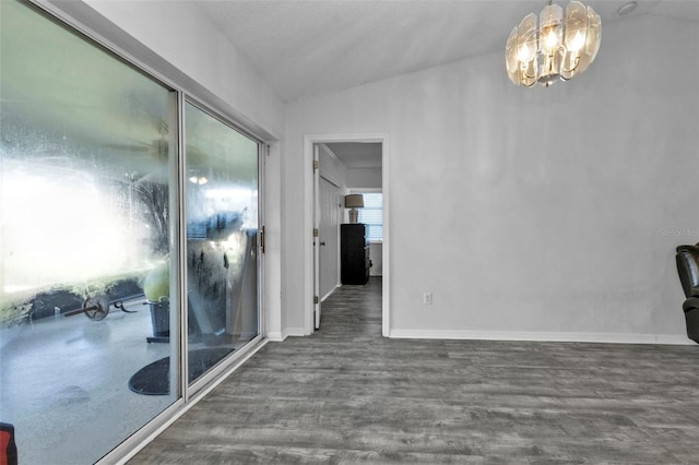 interior space with a textured ceiling, dark hardwood / wood-style floors, vaulted ceiling, and a notable chandelier