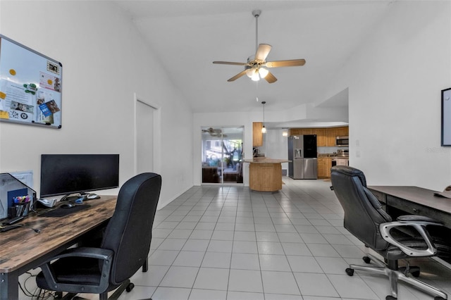 office space featuring ceiling fan, light tile patterned flooring, and vaulted ceiling