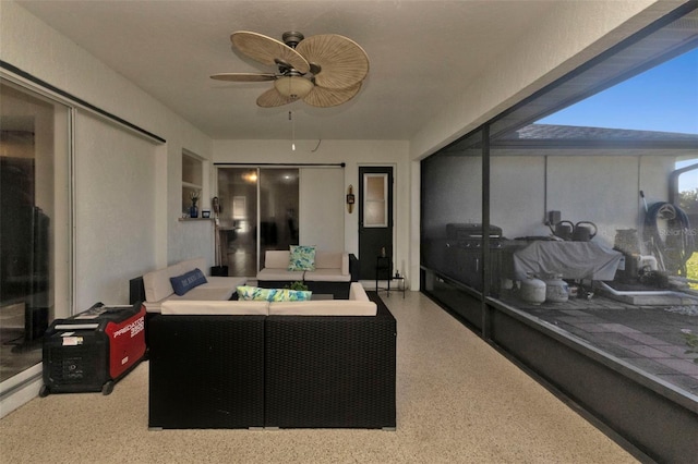 interior space featuring outdoor lounge area and ceiling fan