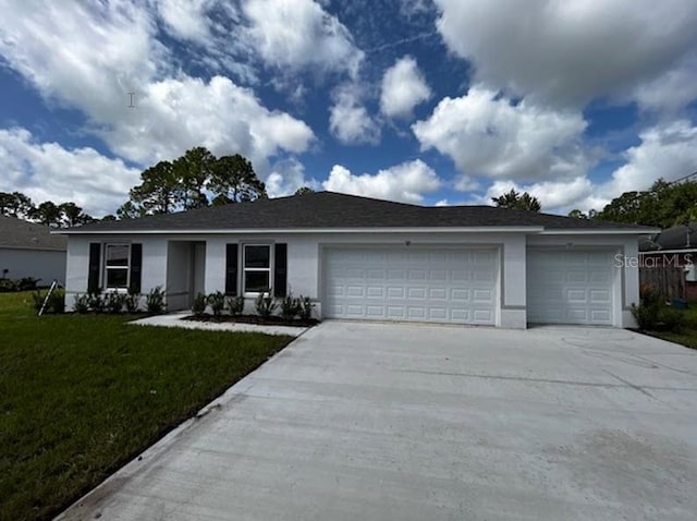 single story home with a garage and a front lawn