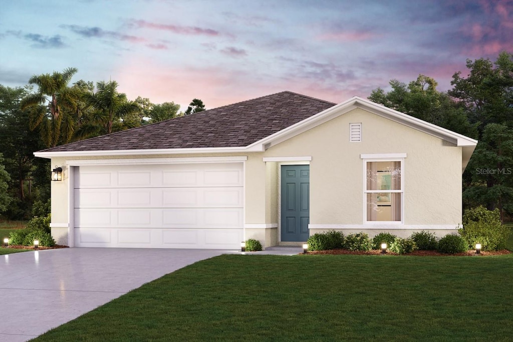 ranch-style house with stucco siding, an attached garage, driveway, and a front yard