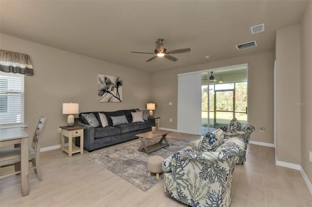 living room with ceiling fan and light hardwood / wood-style floors