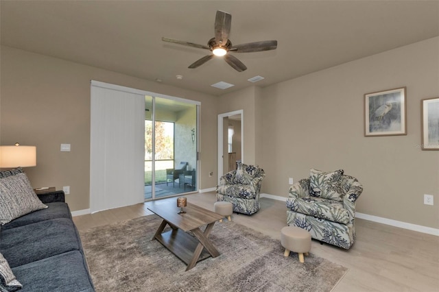 living room with light wood-type flooring and ceiling fan