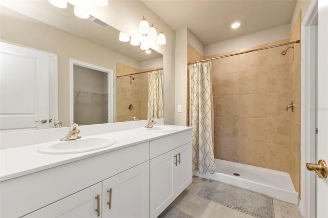 bathroom with vanity and curtained shower