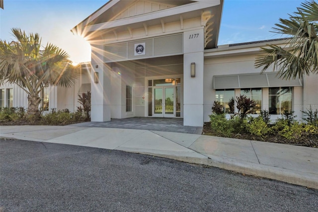 exterior entry at dusk featuring french doors