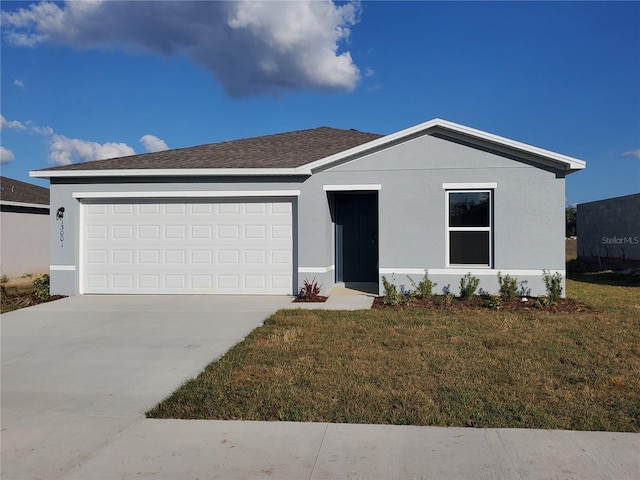 view of front facade with a front yard and a garage