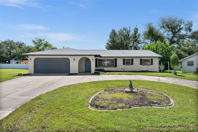 single story home featuring a front lawn and a garage